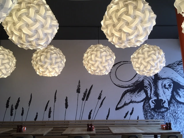 Elegant white floral lamps and modern artwork for chic interior decor.