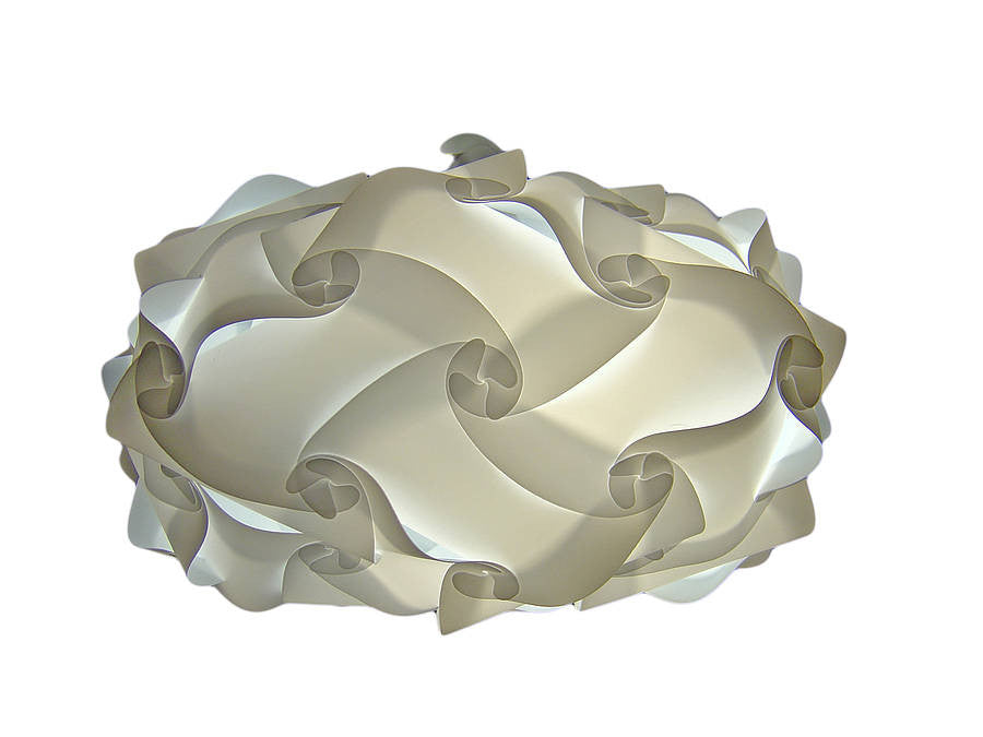 Elegant pleated white lampshade with intricate swirling design, creating a soft, diffused lighting effect