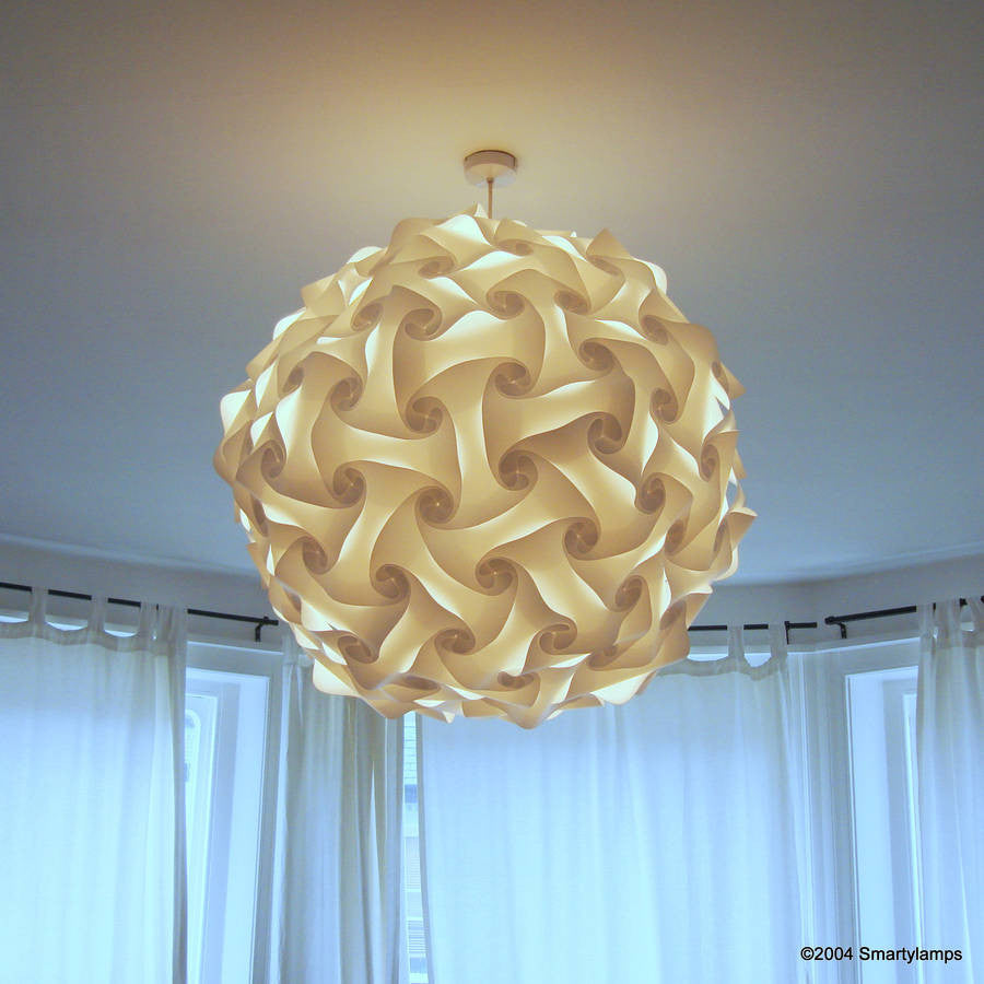 Elegant contemporary ceiling light fixture with intricate swirling design, creating a focal point in the bright, airy room.