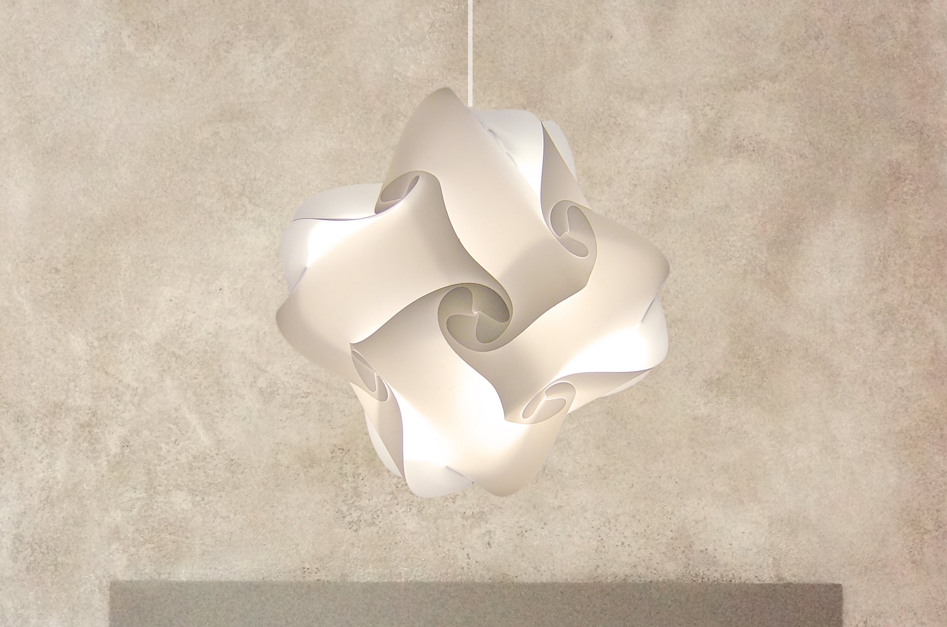 Elegant white Smarty Lamps Axelle Ceiling Lampshade, featuring a sculptural, floral-inspired design suspended against a neutral background.