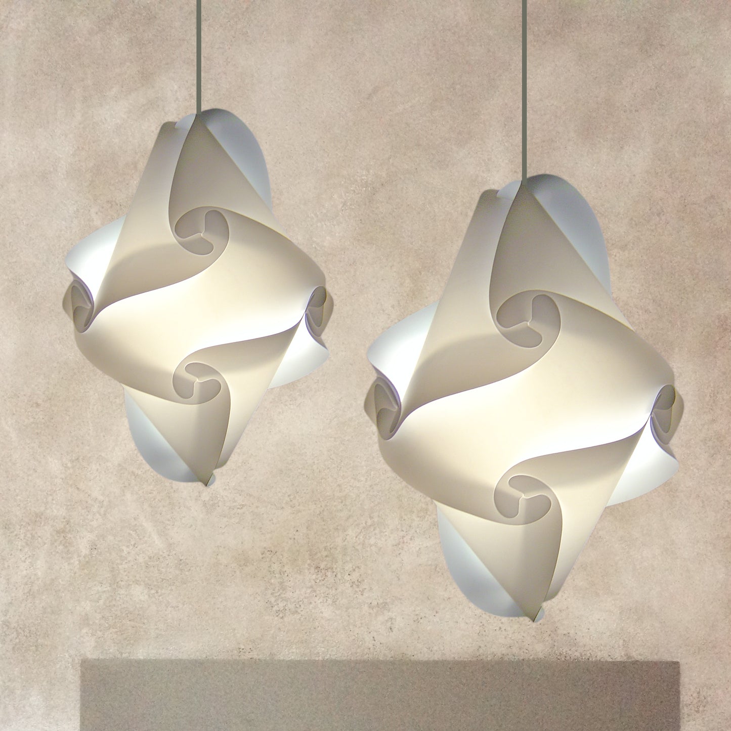 Elegant white swirled lampshades in modern lighting design, suspended against a neutral background.