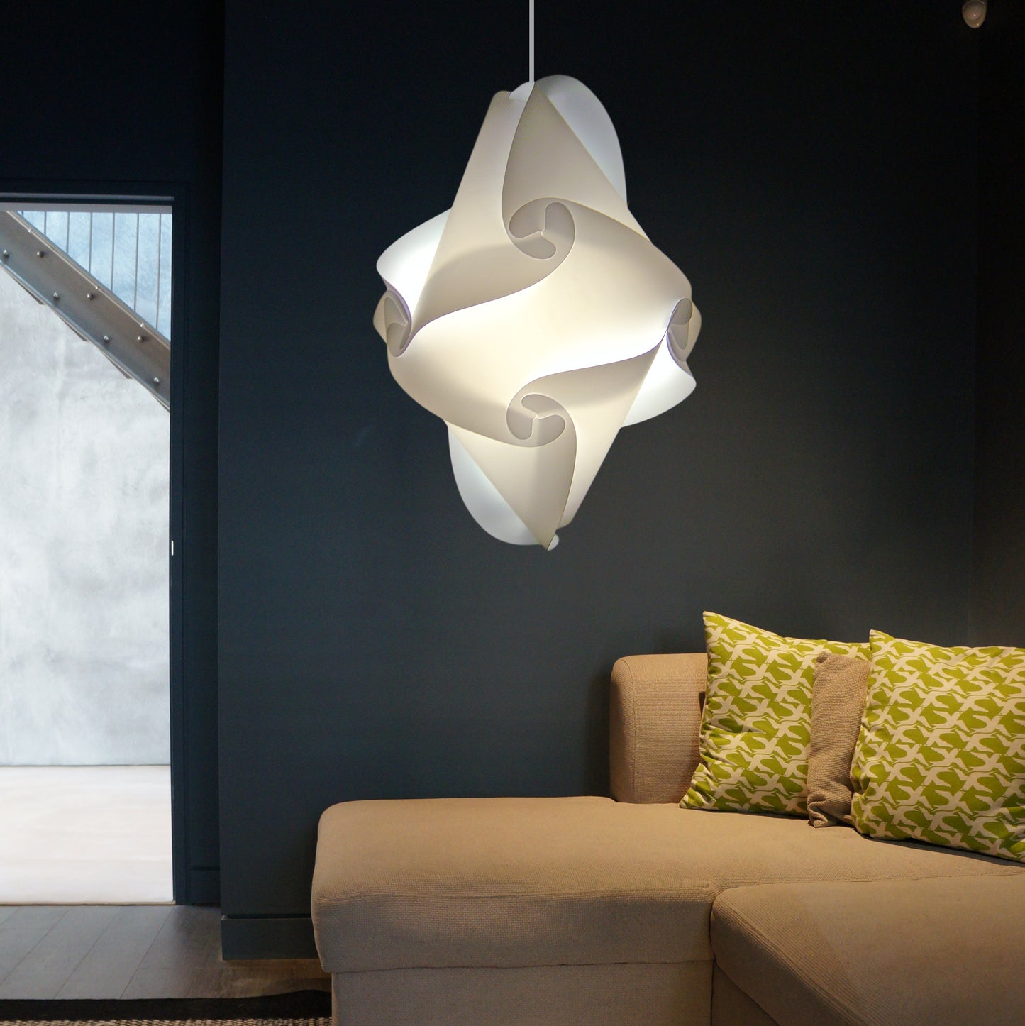 Elegant white pendant lamp illuminating modern living room with beige sofa and patterned cushions.