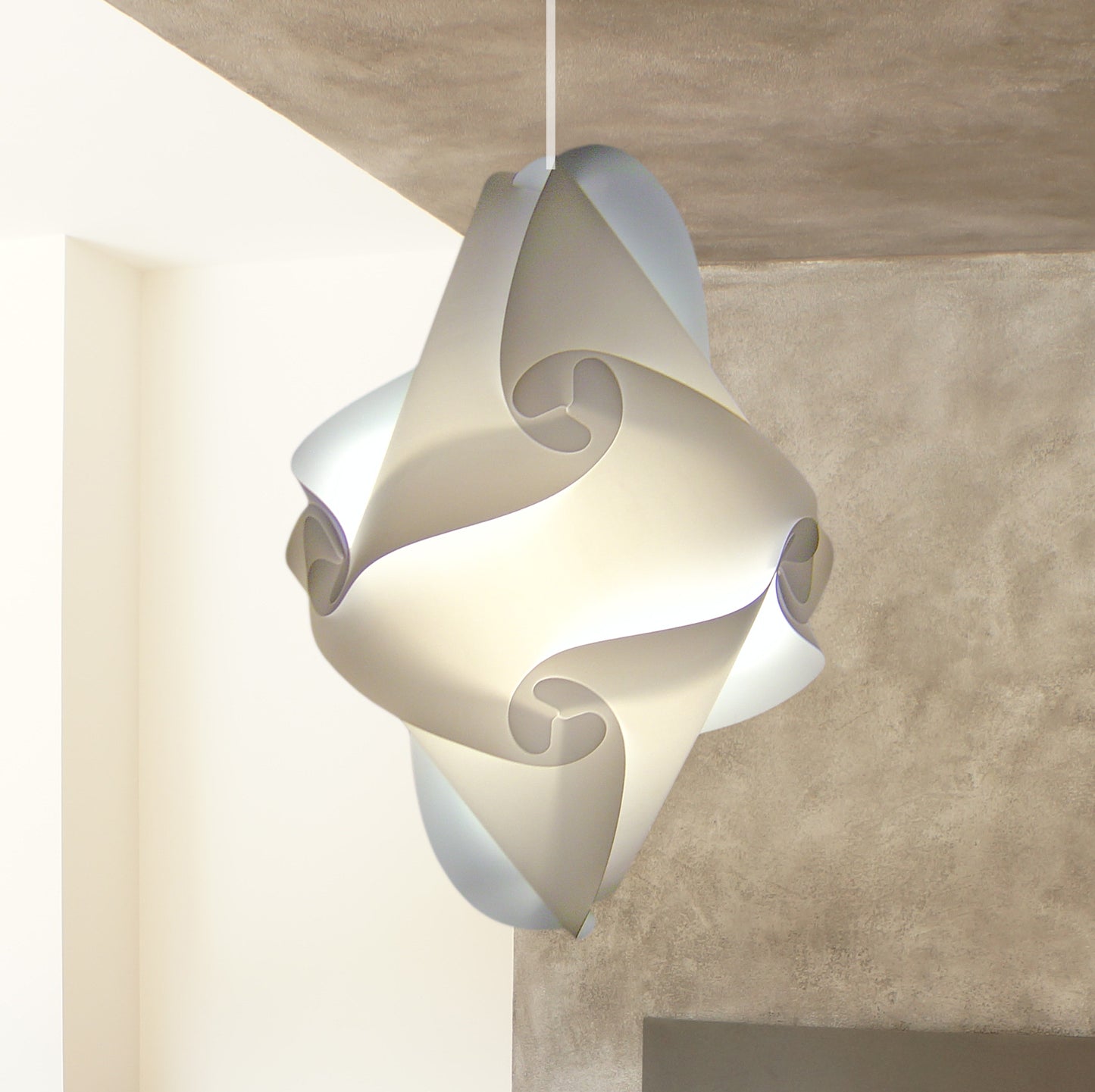 Elegant white geometric pendant lamp with a sculptural, twisting design, adding a modern touch to the interior space.
