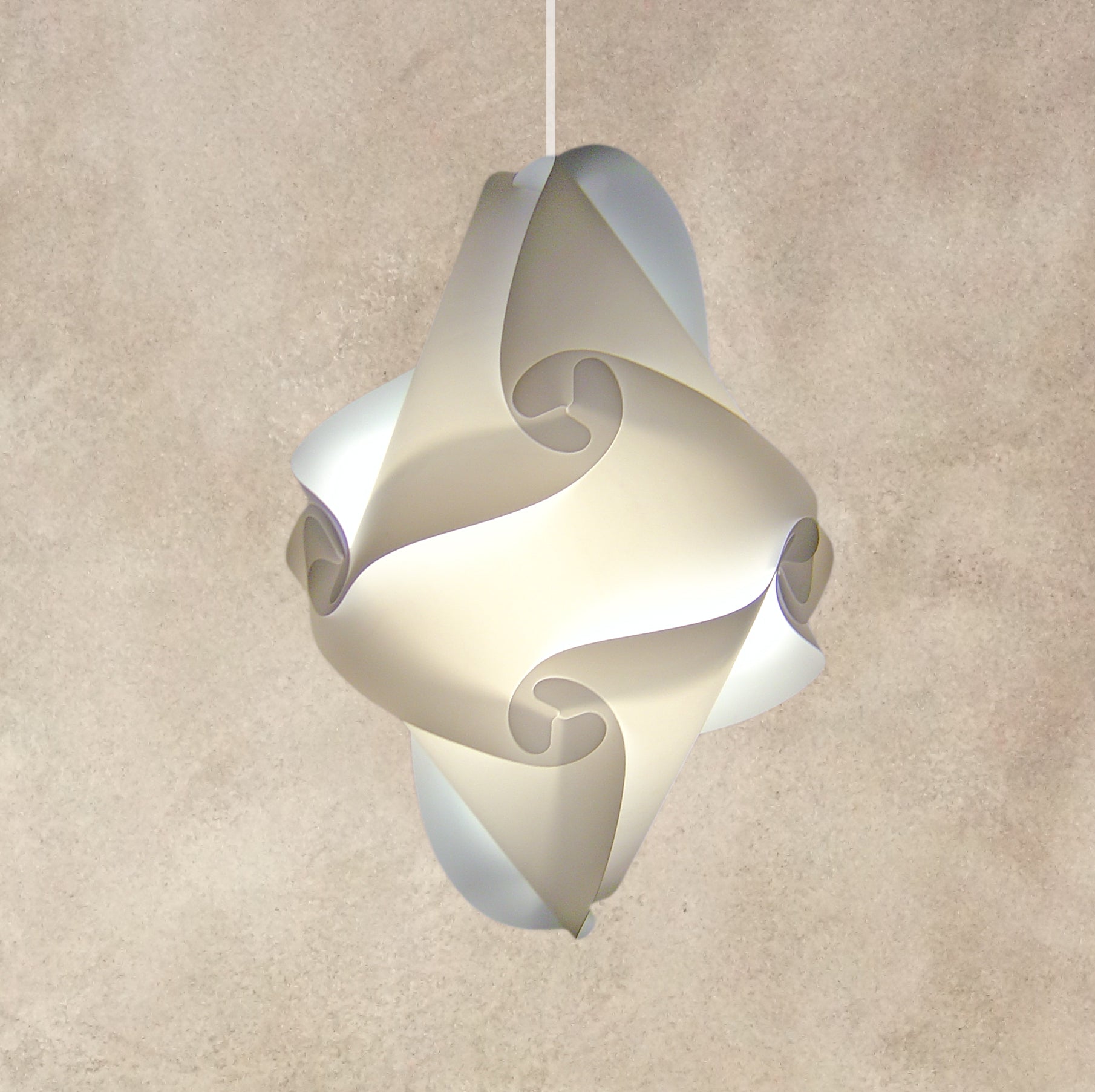 Modern white sculptural lampshade with swirling patterns hanging against a beige textured wall