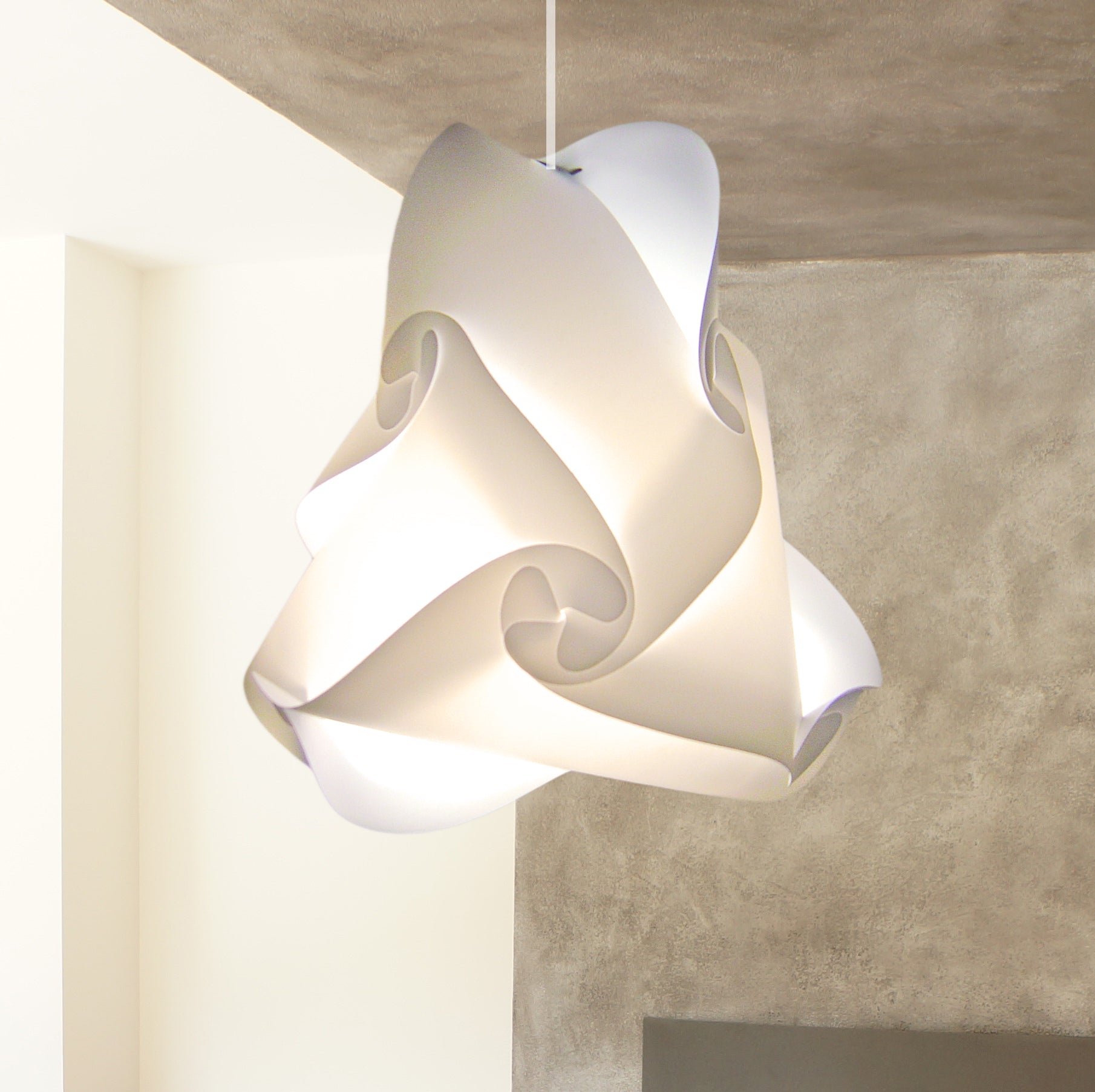 Elegant white swirling lampshade suspended from the ceiling in a modern interior setting