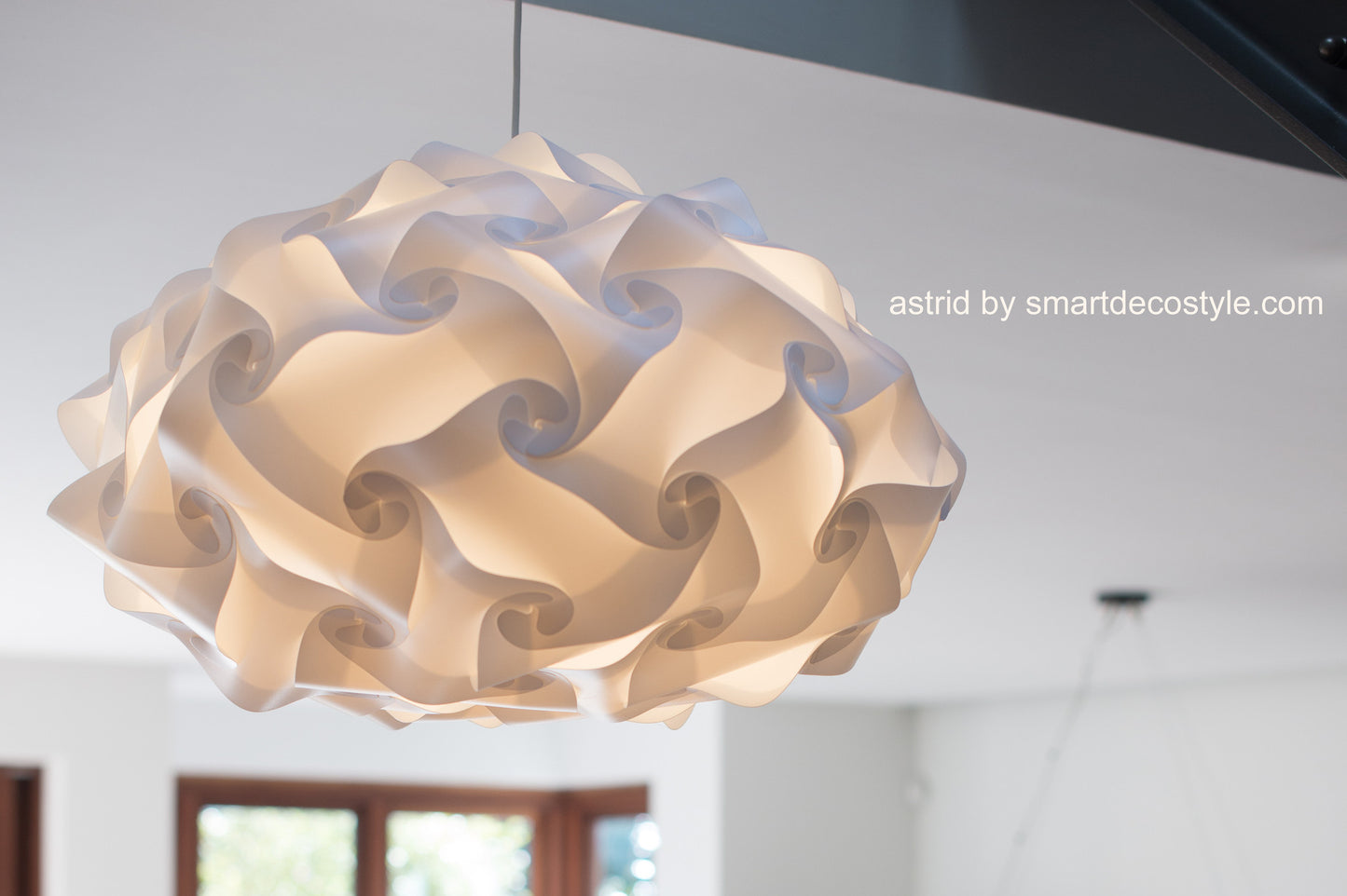 Elegant white swirl lamp shade by Smarty Lamps, suspended from ceiling, creates soft ambiance in room interior