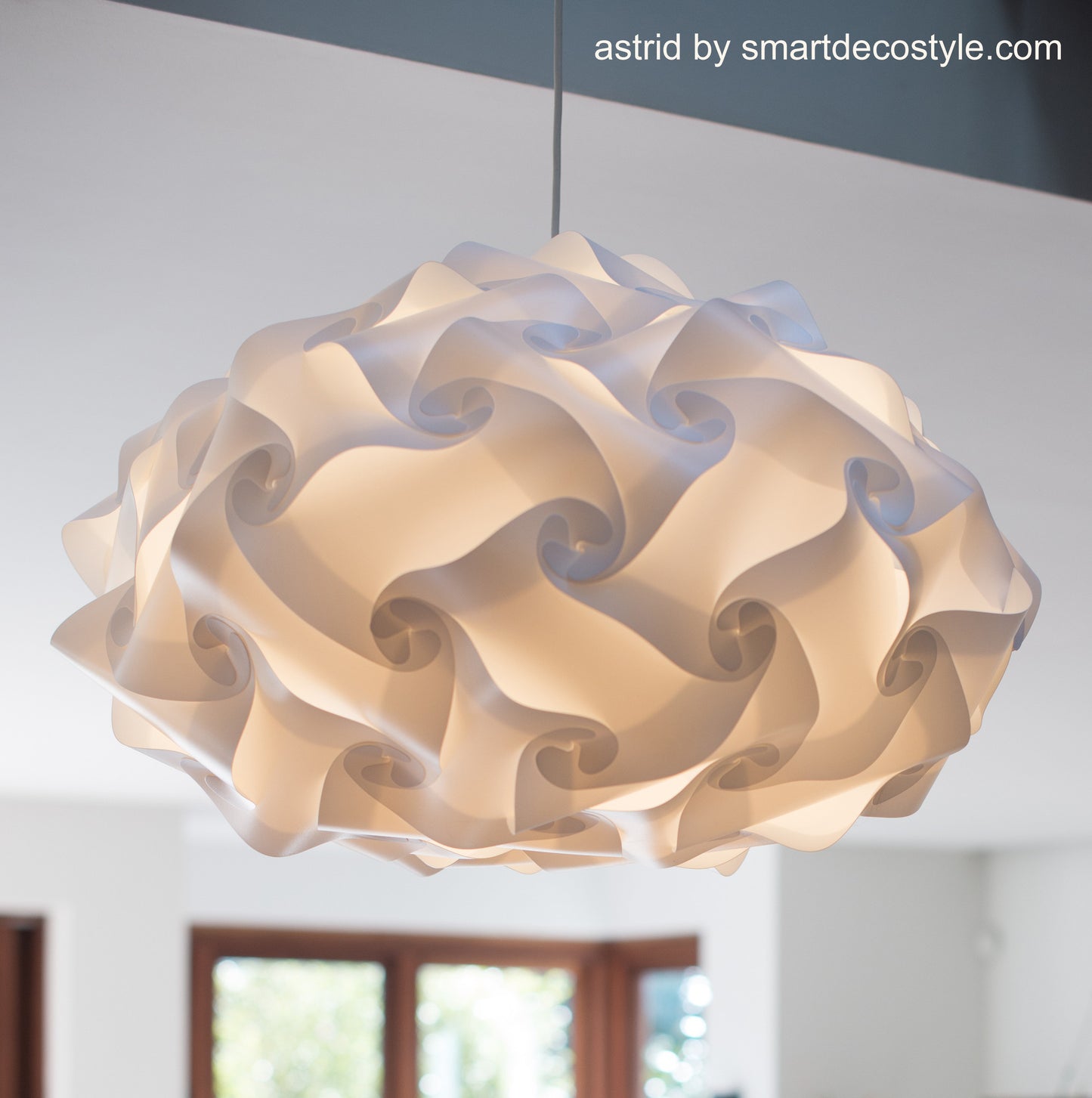 Elegant Pleated Lampshade by Smarty Lamps - A sculptural lighting feature with a swirling, organic design, casting a warm, diffused glow in modern interiors.