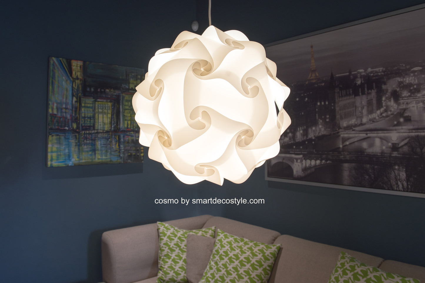 Stylish white swirl-patterned lampshade hanging in a modern interior with decorative cushions