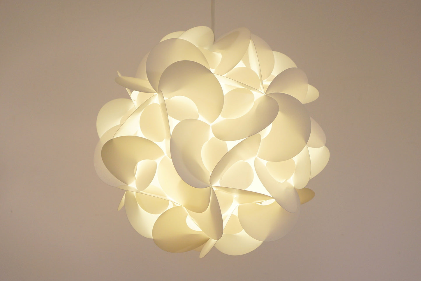 Elegant white curved lighting fixture on soft background