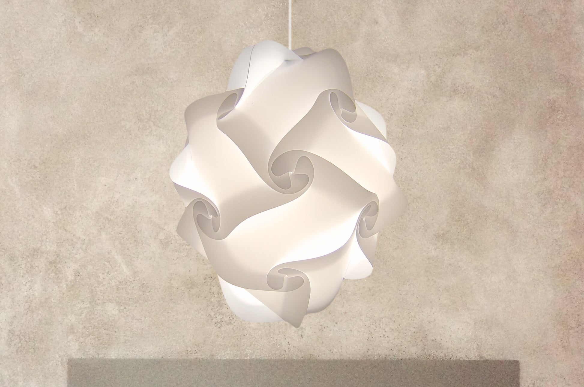 Sculptural white ceiling lampshade, modern lighting fixture with intricate curved form, suspended from ceiling, minimalist decor piece