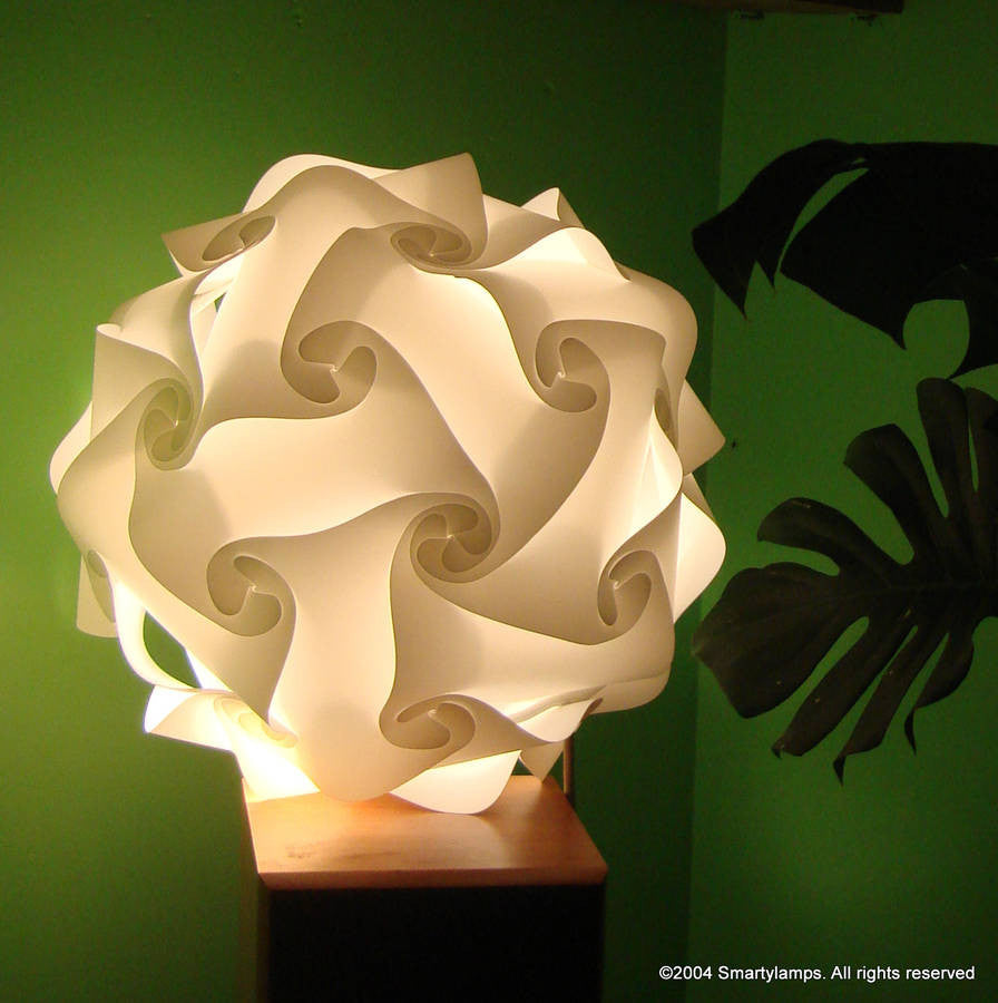 Modern swirled white lamp shade against green background